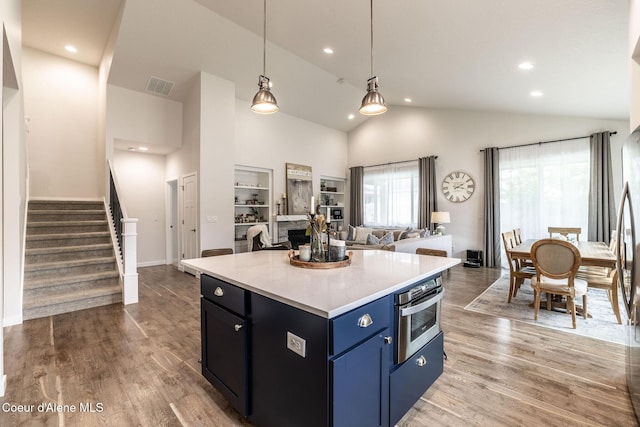 1769 N Chetco Dr, Post Falls, ID 83854 - kitchen featuring stainless steel oven, blue cabinetry, light countertops, recessed lighting, and light wood-type flooring