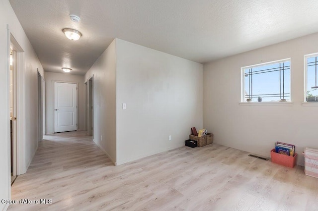 3316 N Van Winkle St, Post Falls, ID 83854 - unfurnished room featuring light wood-style flooring and a textured ceiling