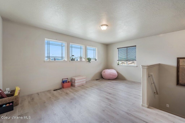 3316 N Van Winkle St, Post Falls, ID 83854 - unfurnished bedroom featuring wood finished floors and a textured ceiling