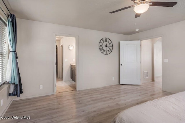 3316 N Van Winkle St, Post Falls, ID 83854 - unfurnished bedroom with light wood finished floors, ensuite bath, baseboards, and a ceiling fan