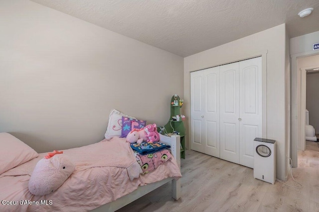3316 N Van Winkle St, Post Falls, ID 83854 - bedroom featuring light wood finished floors, a closet, and a textured ceiling