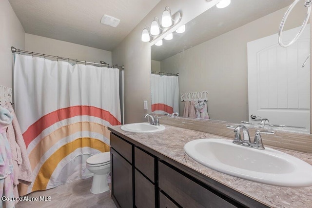 3316 N Van Winkle St, Post Falls, ID 83854 - full bathroom featuring toilet, double vanity, and a shower with shower curtain