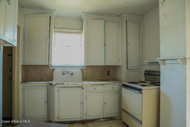 2224 N Park Rd, Spokane Valley, WA 99212 - kitchen featuring white range with electric cooktop, a sink, light countertops, and backsplash