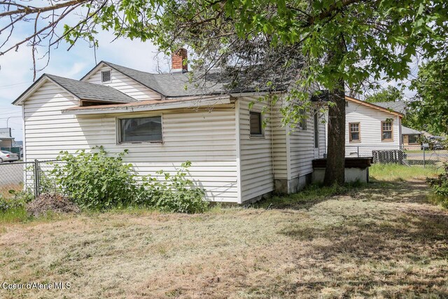 2224 N Park Rd, Spokane Valley, WA 99212 - view of side of property featuring fence, roof with shingles, and a chimney