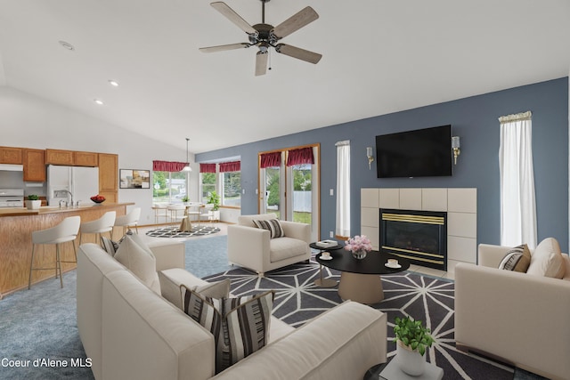 carpeted living room with ceiling fan, a fireplace, recessed lighting, and high vaulted ceiling