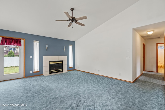 unfurnished living room with carpet flooring, healthy amount of natural light, a tiled fireplace, and high vaulted ceiling
