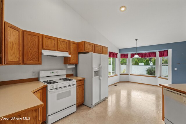kitchen with white appliances, under cabinet range hood, brown cabinetry, light countertops, and high vaulted ceiling