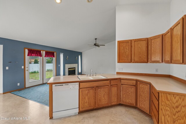 kitchen featuring white dishwasher, a sink, a peninsula, open floor plan, and ceiling fan