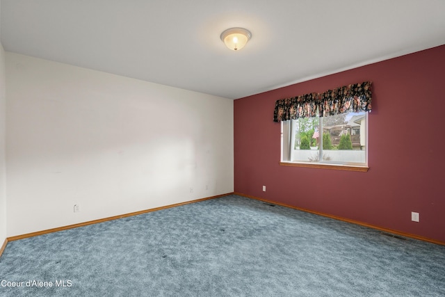 carpeted spare room with baseboards