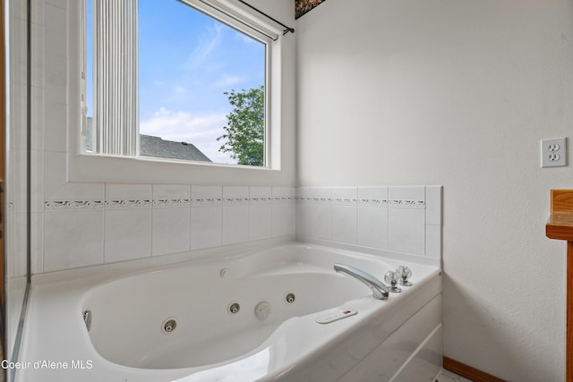 bathroom with a tub with jets