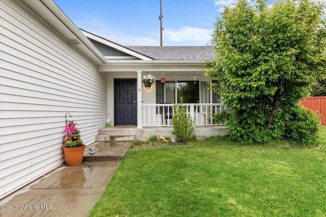 1135 W Wishkah Ave, Post Falls, ID 83854 - doorway to property featuring covered porch, a lawn, and roof with shingles