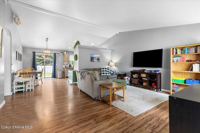1135 W Wishkah Ave, Post Falls, ID 83854 - living room featuring wood finished floors, lofted ceiling, a chandelier, and baseboards