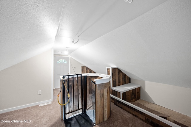 376 Second St, Mullan, ID 83846 - bonus room featuring carpet floors, vaulted ceiling, a textured ceiling, and baseboards