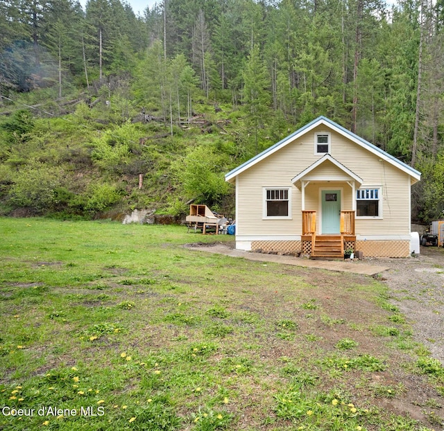 376 Second St, Mullan, ID 83846 - view of front facade with a forest view and a front yard