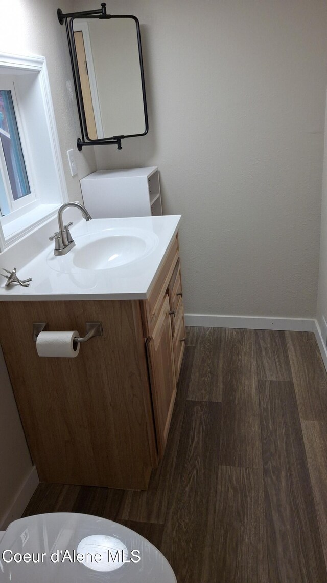 376 Second St, Mullan, ID 83846 - bathroom with vanity, wood finished floors, and baseboards