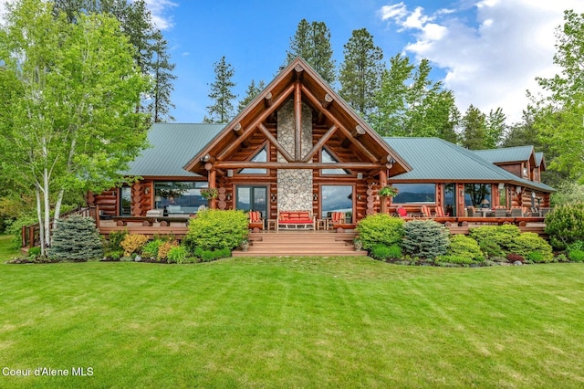 271 W Shore Ln, Sandpoint, ID 83864 - rear view of property with log siding and a lawn