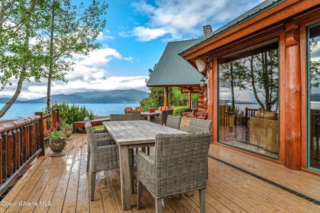 271 W Shore Ln, Sandpoint, ID 83864 - wooden terrace featuring a water and mountain view and outdoor dining area