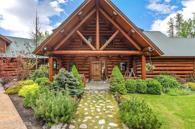 271 W Shore Ln, Sandpoint, ID 83864 - rear view of house with log exterior and a lawn