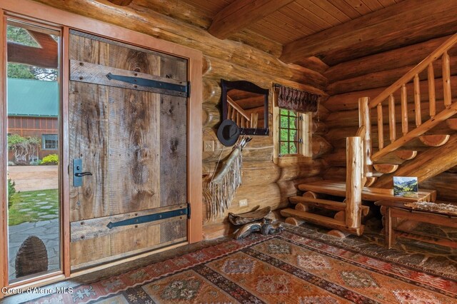 271 W Shore Ln, Sandpoint, ID 83864 - foyer entrance featuring rustic walls and wooden ceiling with exposed beams