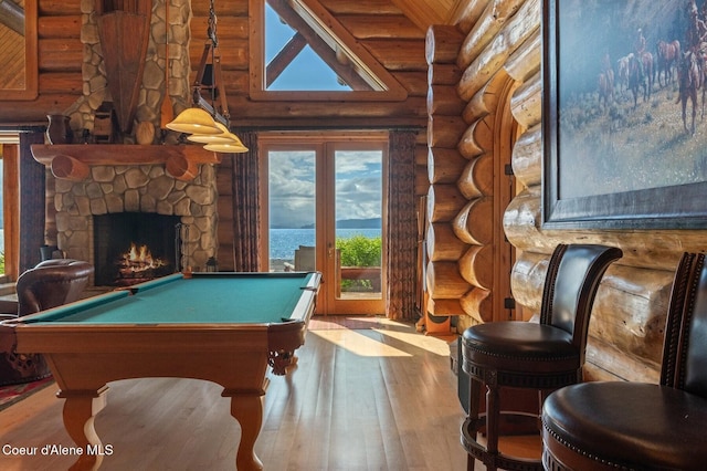 271 W Shore Ln, Sandpoint, ID 83864 - game room with hardwood / wood-style flooring, rustic walls, billiards, and a stone fireplace