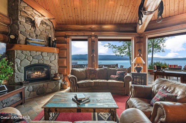 271 W Shore Ln, Sandpoint, ID 83864 - living room featuring rustic walls, a fireplace, wooden ceiling with exposed beams, stone finish floors, and a water view