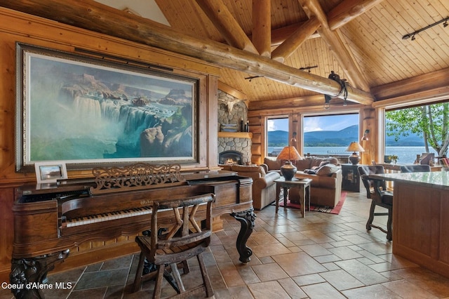 271 W Shore Ln, Sandpoint, ID 83864 - dining space with wooden ceiling, plenty of natural light, a fireplace, and stone tile floors