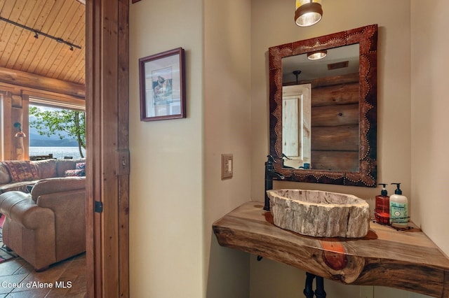 271 W Shore Ln, Sandpoint, ID 83864 - bathroom with a sink, log walls, and wood ceiling