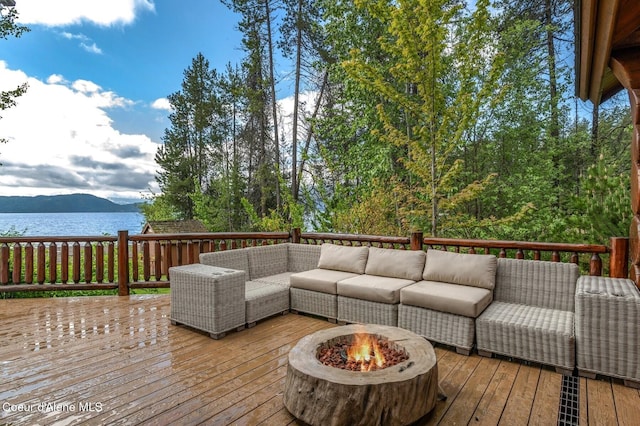 271 W Shore Ln, Sandpoint, ID 83864 - deck featuring an outdoor living space with a fire pit and a water view