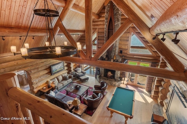 271 W Shore Ln, Sandpoint, ID 83864 - living area with wood ceiling with exposed beams, log walls, a fireplace, wood finished floors, and high vaulted ceiling