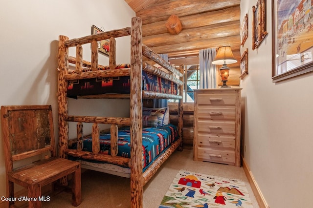 271 W Shore Ln, Sandpoint, ID 83864 - carpeted bedroom featuring rustic walls