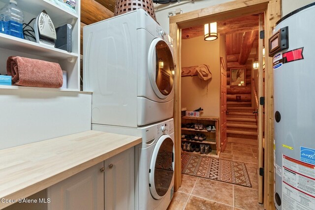 271 W Shore Ln, Sandpoint, ID 83864 - washroom with stacked washer and clothes dryer, cabinet space, and light tile patterned floors