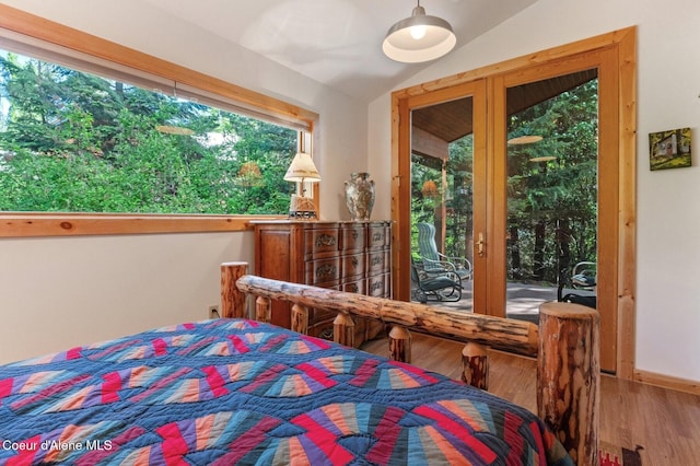 271 W Shore Ln, Sandpoint, ID 83864 - bedroom featuring lofted ceiling, access to outside, and wood finished floors