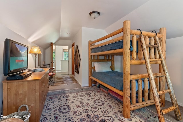 271 W Shore Ln, Sandpoint, ID 83864 - bedroom with carpet flooring, vaulted ceiling, and baseboards