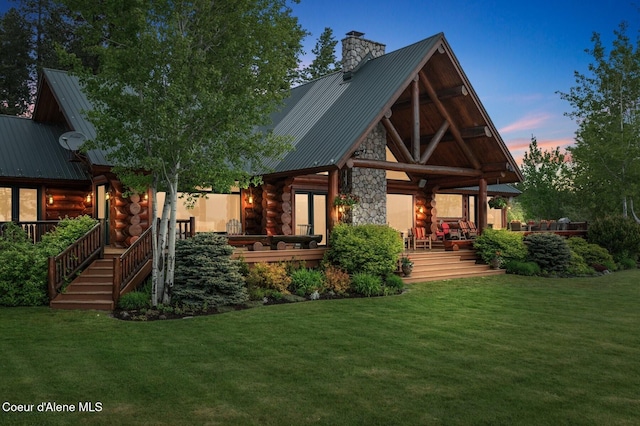 271 W Shore Ln, Sandpoint, ID 83864 - rear view of property featuring log exterior, metal roof, a yard, and a chimney