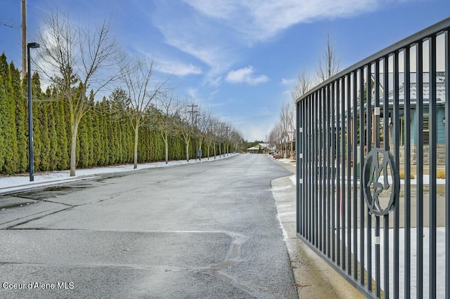 4362 N Meadow Ranch Ave, Coeur Dalene, ID 83815 - view of asphalt street featuring street lights and a gate