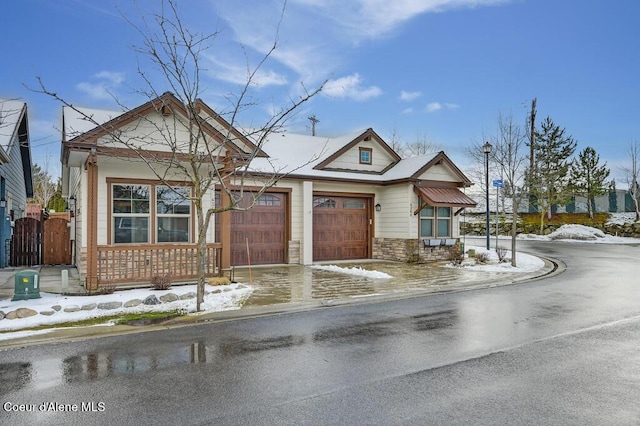 4362 N Meadow Ranch Ave, Coeur Dalene, ID 83815 - view of front facade featuring an attached garage, stone siding, concrete driveway, and covered porch