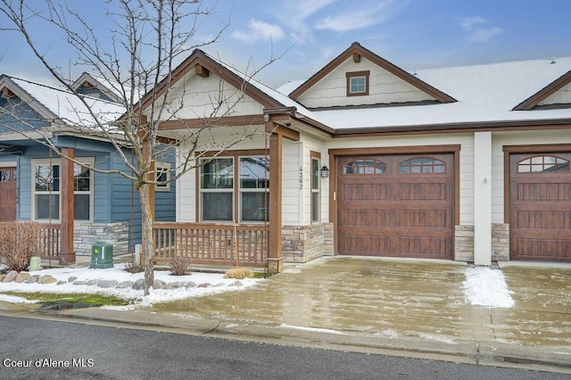 4362 N Meadow Ranch Ave, Coeur Dalene, ID 83815 - view of front of property featuring stone siding, a garage, and concrete driveway