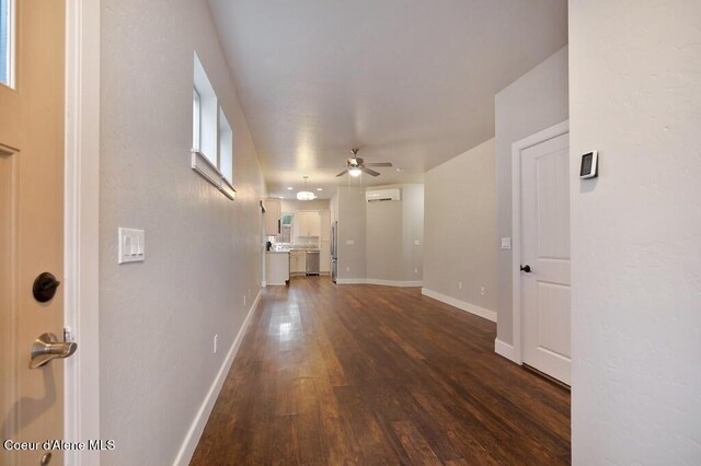 4362 N Meadow Ranch Ave, Coeur Dalene, ID 83815 - hall with dark wood-type flooring, a wall unit AC, and baseboards