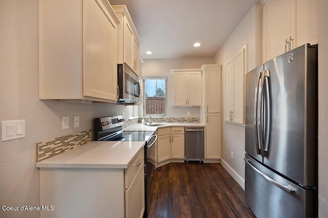 4362 N Meadow Ranch Ave, Coeur Dalene, ID 83815 - kitchen featuring appliances with stainless steel finishes, light countertops, dark wood finished floors, recessed lighting, and baseboards