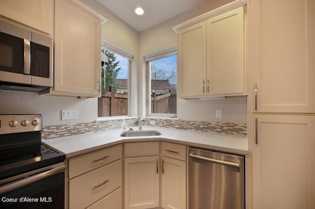 4362 N Meadow Ranch Ave, Coeur Dalene, ID 83815 - kitchen featuring stainless steel appliances, a sink, light countertops, backsplash, and recessed lighting