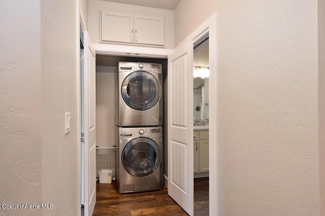 4362 N Meadow Ranch Ave, Coeur Dalene, ID 83815 - washroom featuring estacked washer and dryer, dark wood-style flooring, and a textured wall