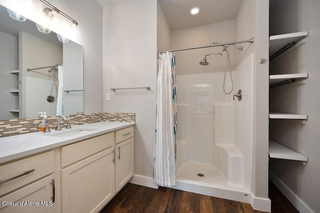 4362 N Meadow Ranch Ave, Coeur Dalene, ID 83815 - bathroom featuring curtained shower, wood finished floors, backsplash, baseboards, and vanity