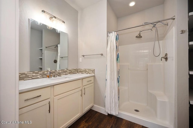 4362 N Meadow Ranch Ave, Coeur Dalene, ID 83815 - full bath featuring a shower with shower curtain, wood finished floors, vanity, decorative backsplash, and recessed lighting