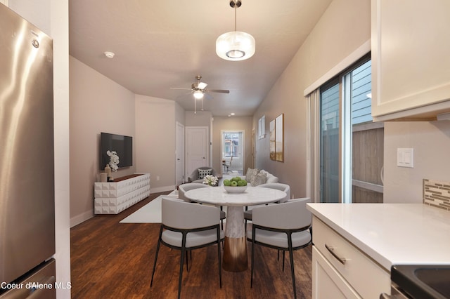 4362 N Meadow Ranch Ave, Coeur Dalene, ID 83815 - dining area with dark wood-style flooring, healthy amount of natural light, a ceiling fan, and baseboards