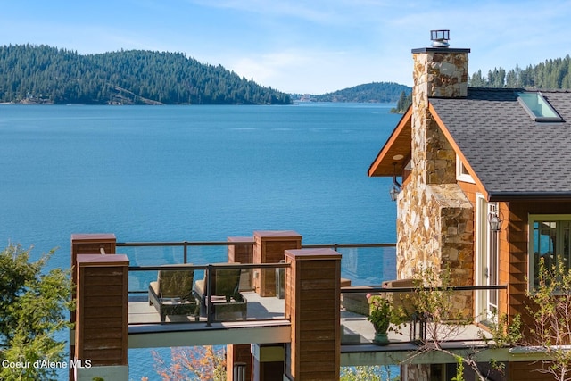 water view featuring mountains and a forest