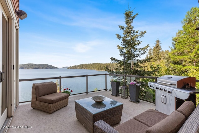 view of patio / terrace with a water view, a balcony, and a grill