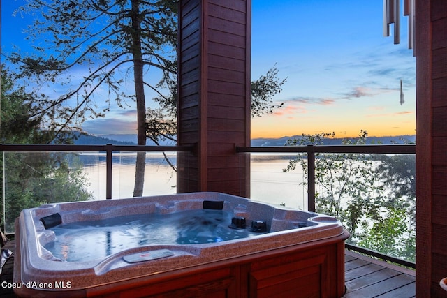 wooden deck with a hot tub