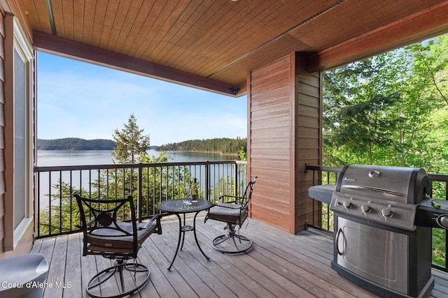 deck featuring a water view and grilling area