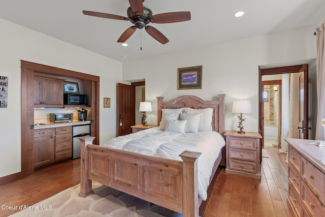 bedroom featuring fridge, hardwood / wood-style floors, recessed lighting, and a ceiling fan