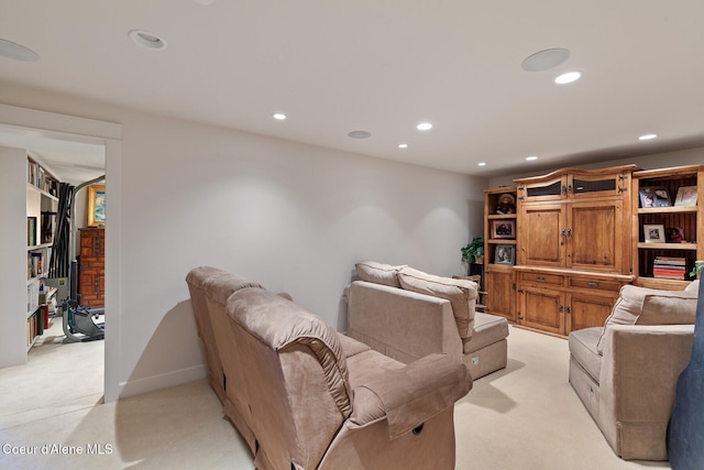 living area featuring light colored carpet and recessed lighting
